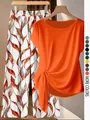 Detail view of the vibrant orange knotted short-sleeve top paired with floral wide-leg pants set - Orange Red