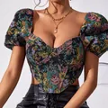 Detail view of a vintage floral tapestry corset top with puff sleeves and boning. - S / Tops / Black
