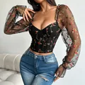 Detailed view of black bustier top with embroidered mesh long sleeves and sweetheart neck - XS / Tops / Black