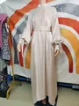 Detail of elegant champagne metallic maxi dress with balloon sleeves and a waist belt - One Size / Dresses / Off White