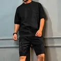 Close-up of black men's summer cargo sports set featuring short sleeves and multi-pocket shorts - Black