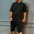 Men's black cargo sports set featuring short sleeves and multi-pocket shorts. - M / Top And Bottom / Black