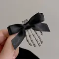 Gothic Halloween black ribbon bow hair clip featuring a silver skeleton hand claw - Bow Skeleton Hand Style (50#) / Black
