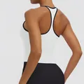 Back view showing the racerback design and black contrast trim on white sports bra - S / Top (7151) / Color Block (White/Black)