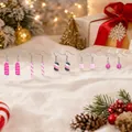 Close-up view of 5 pairs of creative candy-shaped Christmas earrings set on snow - Style 50 (5 Pairs Set) / 5 Pairs Set / Pink