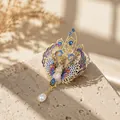 Detailed view of an ornate colorful phoenix brooch with pearl tassel on a stone - Multicolored Phoenix Style