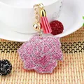 Luxury rhinestone rose keychain with elegant pink tassel and decorative gold bell charm - Pink