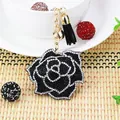 Close-up detail of a luxury black rose keychain featuring white rhinestones and tassel - Black Base Black Rhinestone