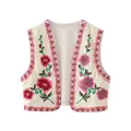 Macro view of colorful floral embroidery and crinkled texture on a boho cream vest - XS / Tops / Red