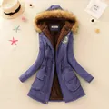 Close-up showing the warm brown faux fur lining and purple fabric of women's parka coat - Sapphire Blue