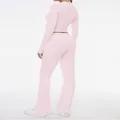 Back view of a slim fit pink two-piece set featuring a long sleeve top and flared pants. - XS / Top And Bottom / Pink