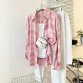 Detailed view of a pink and white plaid chiffon blouse styled with a white mini bag - S / Tops / Pink