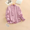 Detail showing elegant ruffle collar and pearlescent buttons on a pink blouse - S / Tops / Pink