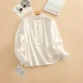 Elegant white ruffled collar blouse featuring pearl buttons and delicate cuff details - S / Tops / White