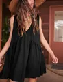 Detailed view of bohemian black V-neck sleeveless pleated mini dress with functional pockets - XS / Dresses / Black