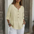 Close-up of summer linen blouse featuring V-neck and wooden button details - S / Tops / Off White