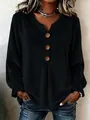 Detail view of black velvet blouse featuring a classic V-neck and decorative wooden buttons - S / Tops / Black