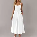 Full view of white smocked midi dress highlighting the flowing skirt and side pockets. - S / Dresses / White
