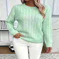 Detail view of mint green cable-knit crewneck sweater with classic braided pattern - Light Green