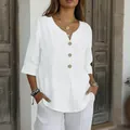 Detailed view of women's white V-neck linen blouse with natural wood buttons - S / Tops / White