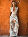 Elegant white jumpsuit with orange floral prints and a deep V-neck for summer style. - S / Set / White
