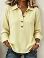 Dettaglio di una maglia a maniche lunghe da donna in tessuto nido d'ape giallo con bottoni. - Taglia S / Top / Giallo chiaro