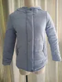 Detailed front view of a light blue hooded winter jacket with warm fleece lining - Light Blue