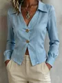 Close-up of light blue slim-fit commute shirt with V-neck and decorative gold buttons - Light Blue