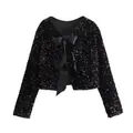 Detail view of black sequined cropped jacket with elegant satin bow front closures. - S / Tops / Black