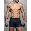 Men's sexy navy blue PU leather slim fit shorts shown from the front on a concrete wall - S / Bottoms / Navy Blue