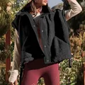Detailed texture of black sherpa fleece vest with snap button closure for women - S / Tops / Black