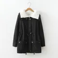 Detailed macro view of women's black parka jacket featuring white faux shearling collar - S / Tops / Black