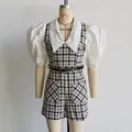 Detailed front view of a checkered short jumpsuit with white puff sleeves on a mannequin - S / Set / Rainbow