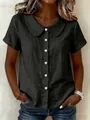 Detailed view of women's black Peter Pan collar blouse with elegant pearl buttons - S / Tops / Black