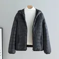 Women's black lightweight hooded puffer jacket featuring a slim fit quilted design - Black