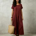 Detail view of the pleated front and texture of a burgundy cotton-linen maxi dress - Burgundy