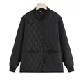 Detailed front view of a black quilted diamond pattern jacket on a wooden hanger - S / Tops / Black