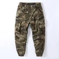 Vintage men's camouflage cargo jogger pants featuring a loose fit and multiple pockets - 29 / Bottoms / Desert Camouflage