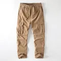 Men's khaki vintage cargo pants featuring a drawstring waist and multiple functional pockets - S / Dark Khaki