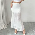 Detail view of high waisted white floral lace maxi skirt with see-through mesh hemline - S / Bottoms / White