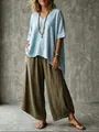 Boho style woman wearing light blue V-neck loose blouse and olive green wide-leg pants - Light Blue