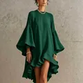 Close-up of elegant green asymmetric dress featuring large bell sleeves and ruffled high-low hem - Dark Green