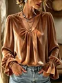 Detail view of an elegant caramel velvet V-neck blouse featuring ruffled cuffs and pleats. - S / Tops / Earthy Yellow