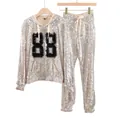 Detailed macro view of two-piece silver sequin hoodie and pants set with digital 88 pattern - S / Top And Bottom / Beige