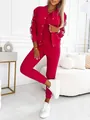 Close-up of a magenta three-piece tracksuit with stylish side stripe details. - Red