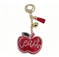 Porte-clés pomme en strass rouge avec cloche dorée et pompon, cadeau idéal pour enseignant. - Pomme à Gland