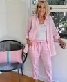 Senior woman wearing pink casual two-piece linen set in a home setting - Pink