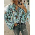 Vue détaillée d'une blouse bohème bleu clair à motif paon avec col en V et boutons - Vert