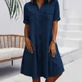 Detail view of a loose blue denim shirt dress with short sleeves and front pockets - 3XL / Dresses / Dark Blue