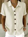 Close-up of casual women's short sleeve linen-cotton shirt with brown buttons detail - Apricot